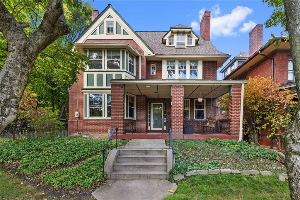 a front view of a house with garden and porch