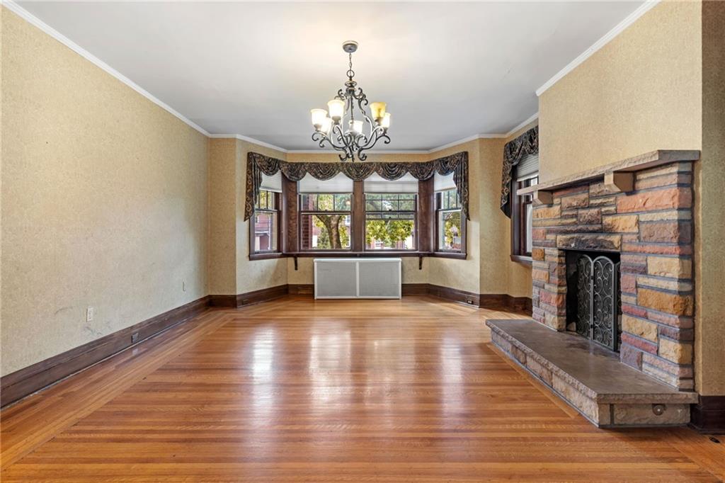 5515 Darlington Road Pittsburgh, PA 15217 - Photo 14 of 50 a view of an empty room with wooden floor and a window