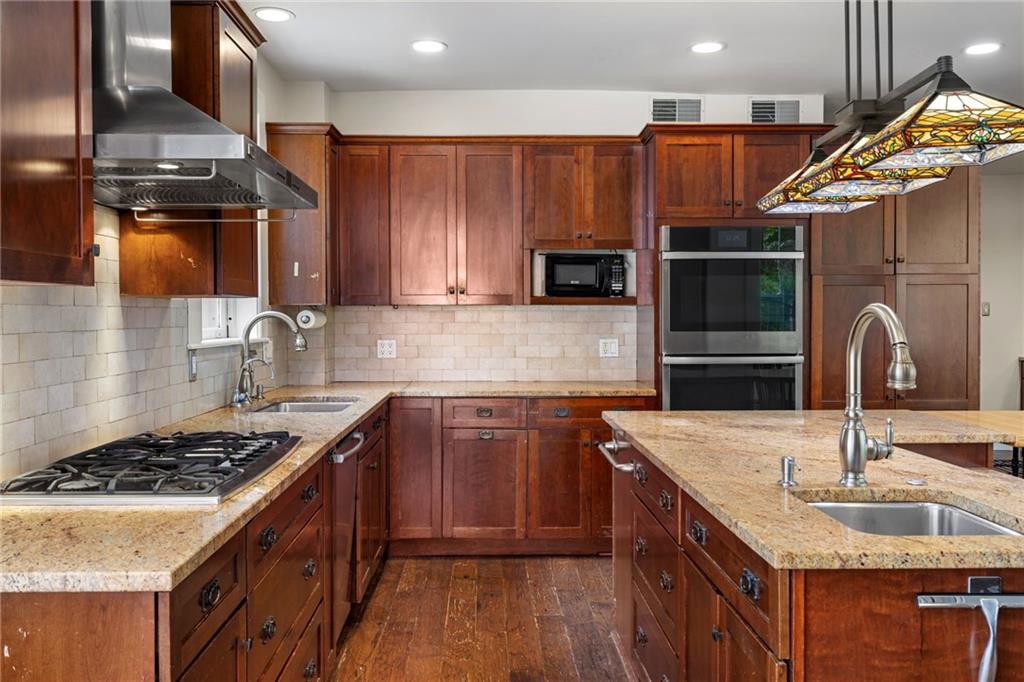 5515 Darlington Road Pittsburgh, PA 15217 - Photo 17 of 50 a kitchen with granite countertop a sink stove and cabinets