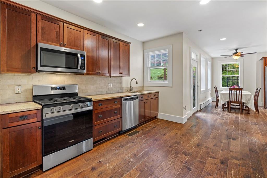 5515 Darlington Road Pittsburgh, PA 15217 - Photo 19 of 50 a kitchen with stainless steel appliances granite countertop wooden cabinets a stove top oven a sink and dishwasher