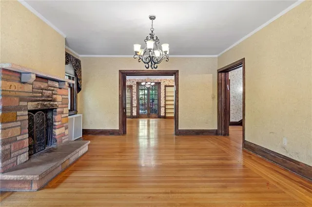 wooden floor fireplace and windows in an empty room