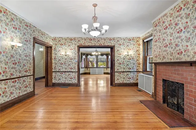 a view of room with wooden floor and windows