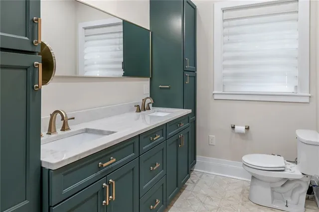 a bathroom with a double vanity sink and a mirror