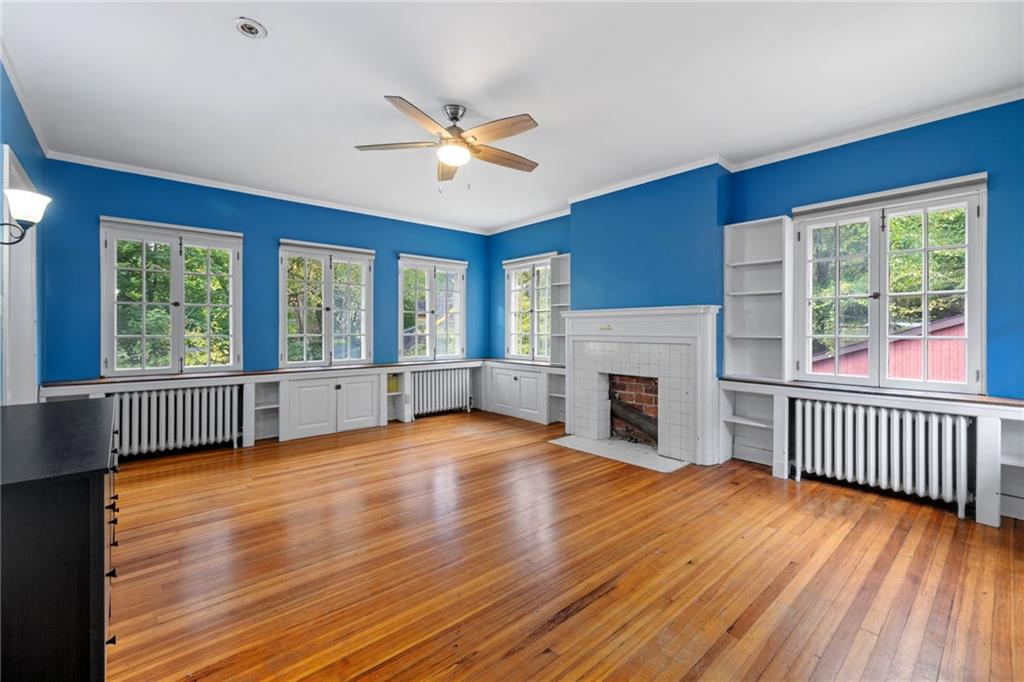 5515 Darlington Road Pittsburgh, PA 15217 - Photo 36 of 50 a view of empty room with wooden floor and fireplace