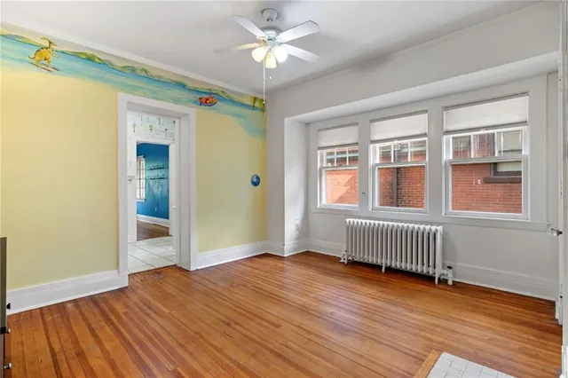 a view of hallway with wooden floor and stairs