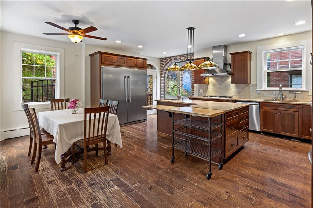5515 Darlington Road Pittsburgh, PA 15217 - Photo 9 of 50 a kitchen with stainless steel appliances granite countertop a stove a sink and a dining table