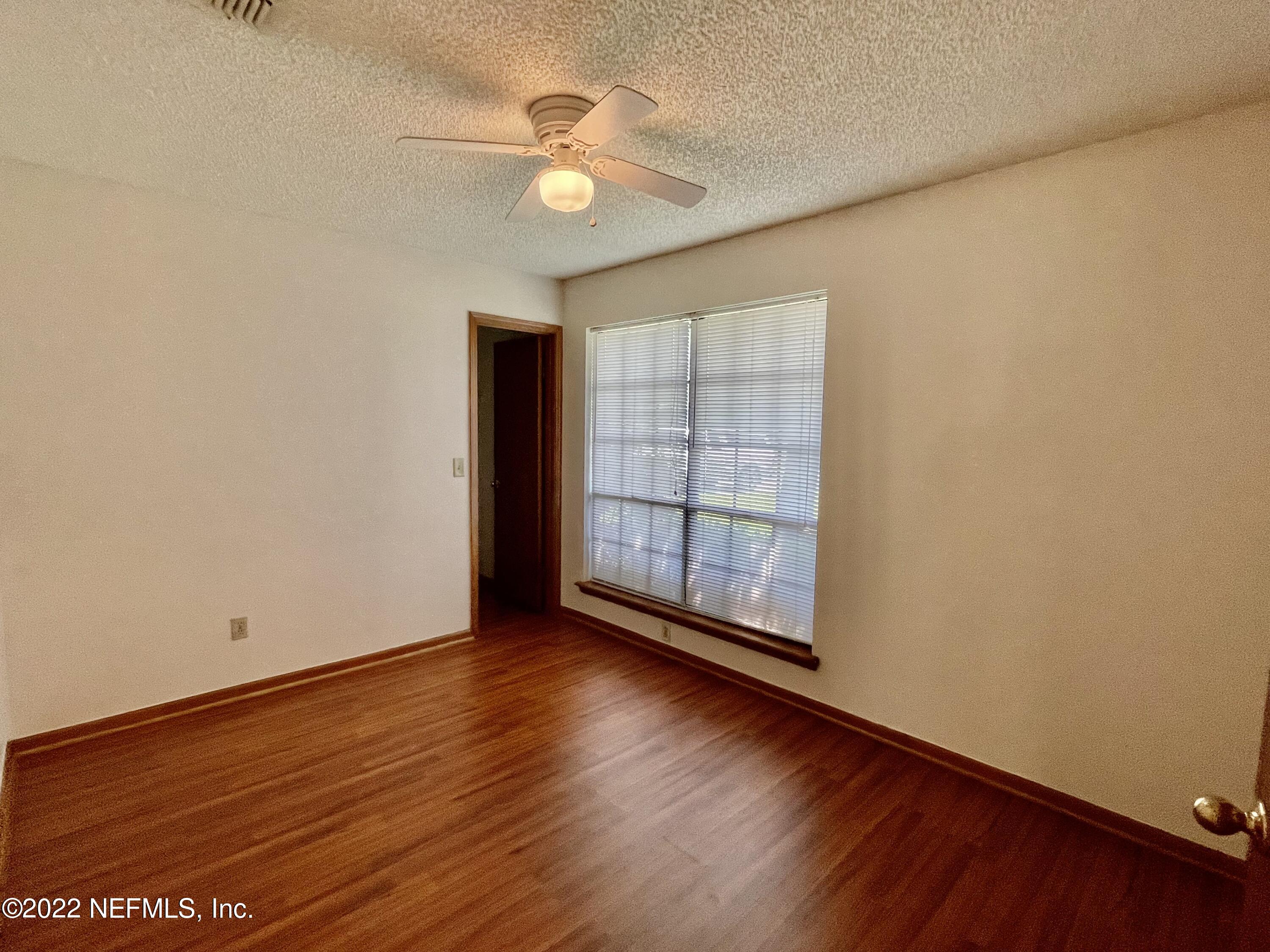 3248 Merganzer Trail Orange Park, FL 32065 - Photo 5 of 17 an empty room with wooden floor and windows