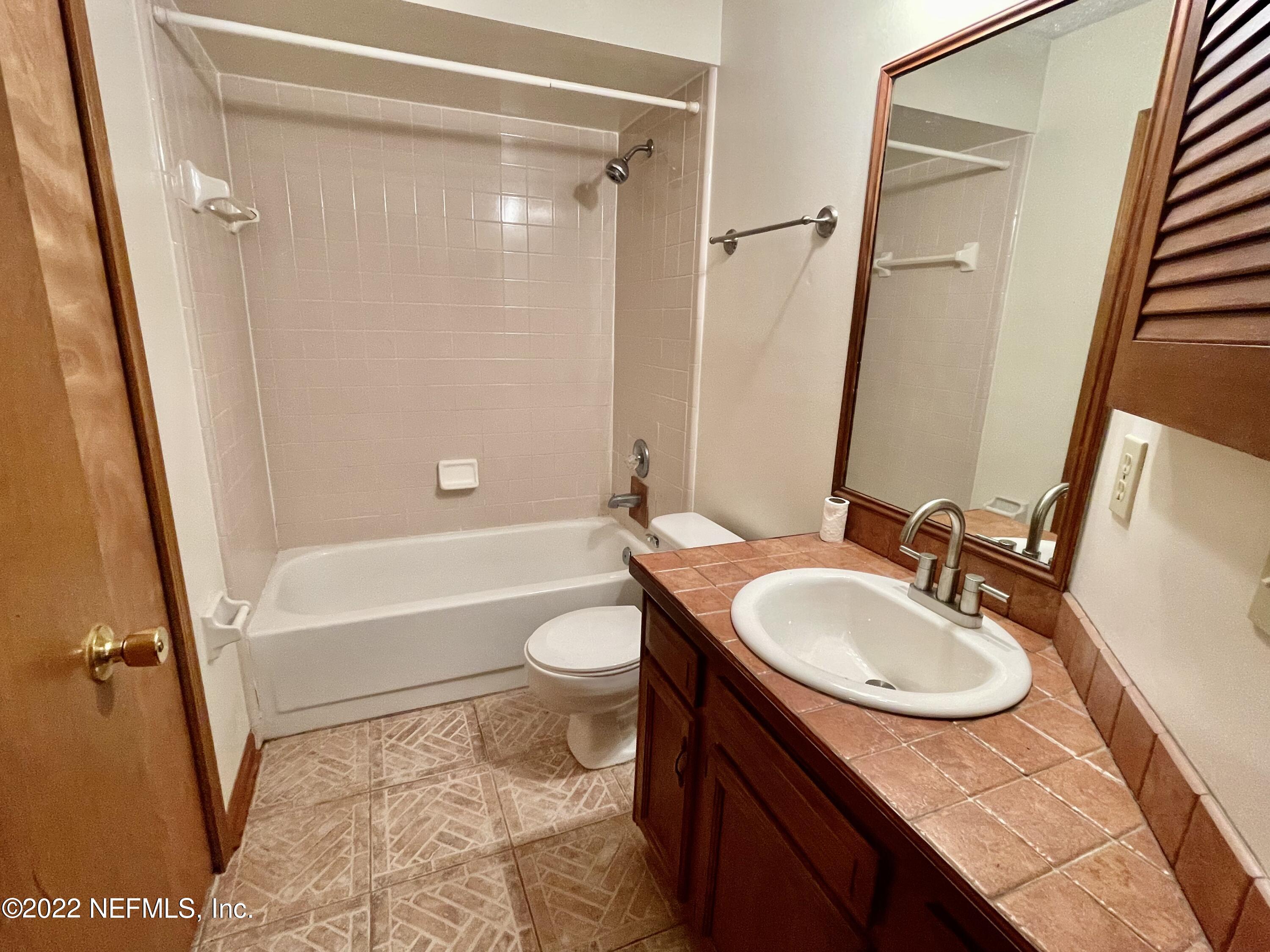 3248 Merganzer Trail Orange Park, FL 32065 - Photo 9 of 17 a bathroom with a sink a toilet and a mirror