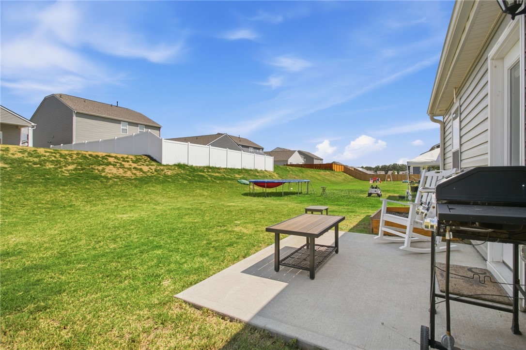 216 Boxbury Way Fountain Inn, SC 29644 - Photo 22 of 28 An open concrete patio steps out onto a spacious, rolling lawn enclosed by privacy fencing.