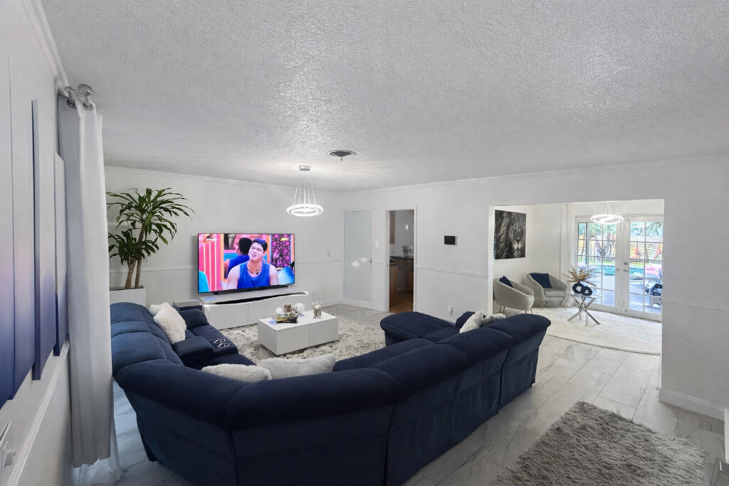 5408 Jackson Street Hollywood, FL 33021 - Photo 11 of 42 a living room with furniture and a flat screen tv