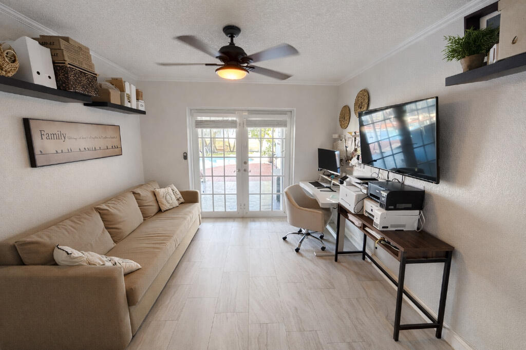 5408 Jackson Street Hollywood, FL 33021 - Photo 13 of 42 a living room with furniture and a flat screen tv