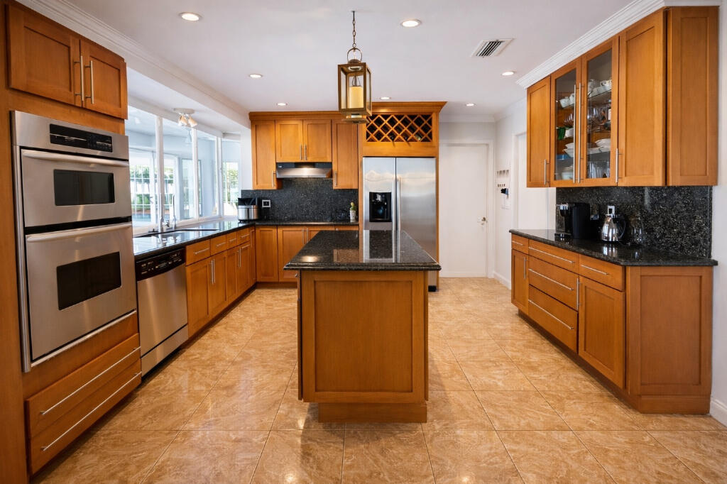 5408 Jackson Street Hollywood, FL 33021 - Photo 18 of 42 a kitchen with stainless steel appliances granite countertop a stove a sink and a microwave