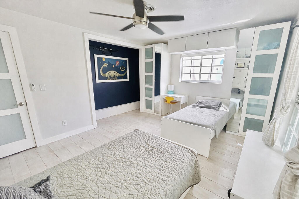 5408 Jackson Street Hollywood, FL 33021 - Photo 19 of 42 a bedroom with a bed and a window