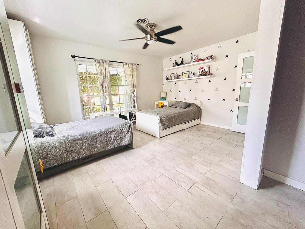5408 Jackson Street Hollywood, FL 33021 - Photo 20 of 42 a bedroom with a bed and window