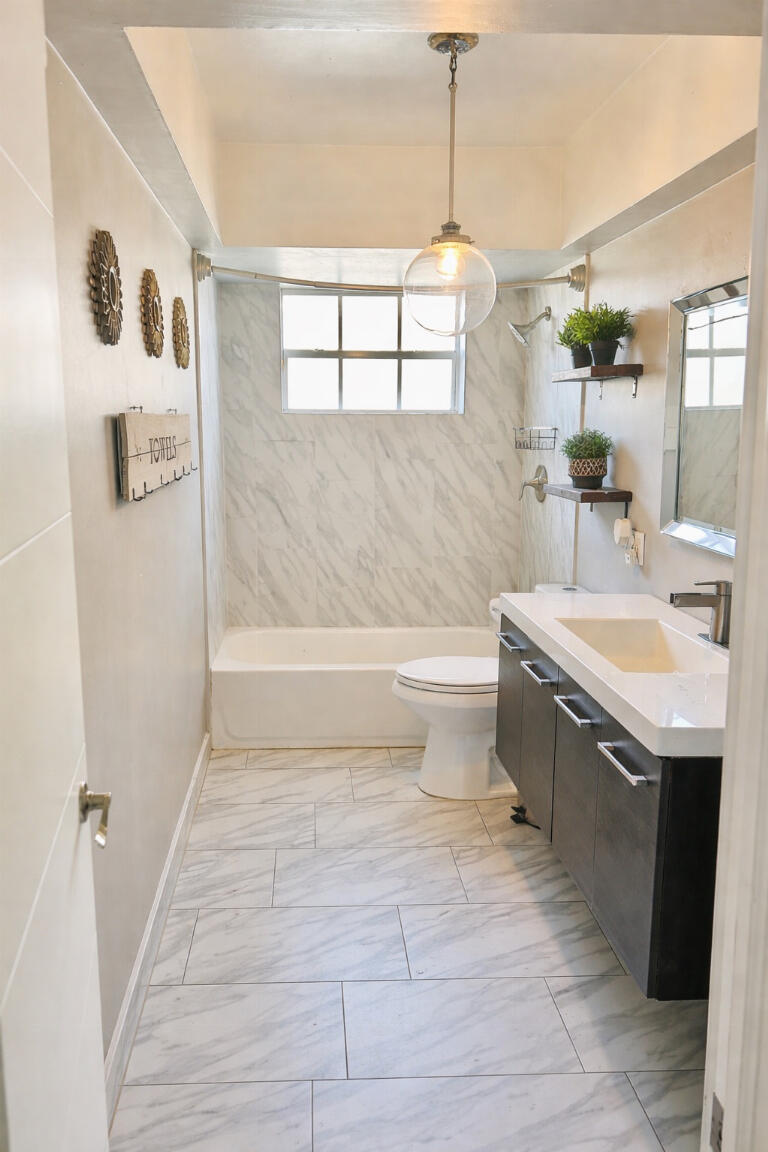 5408 Jackson Street Hollywood, FL 33021 - Photo 22 of 42 a bathroom with a sink a toilet a mirror and bathtub