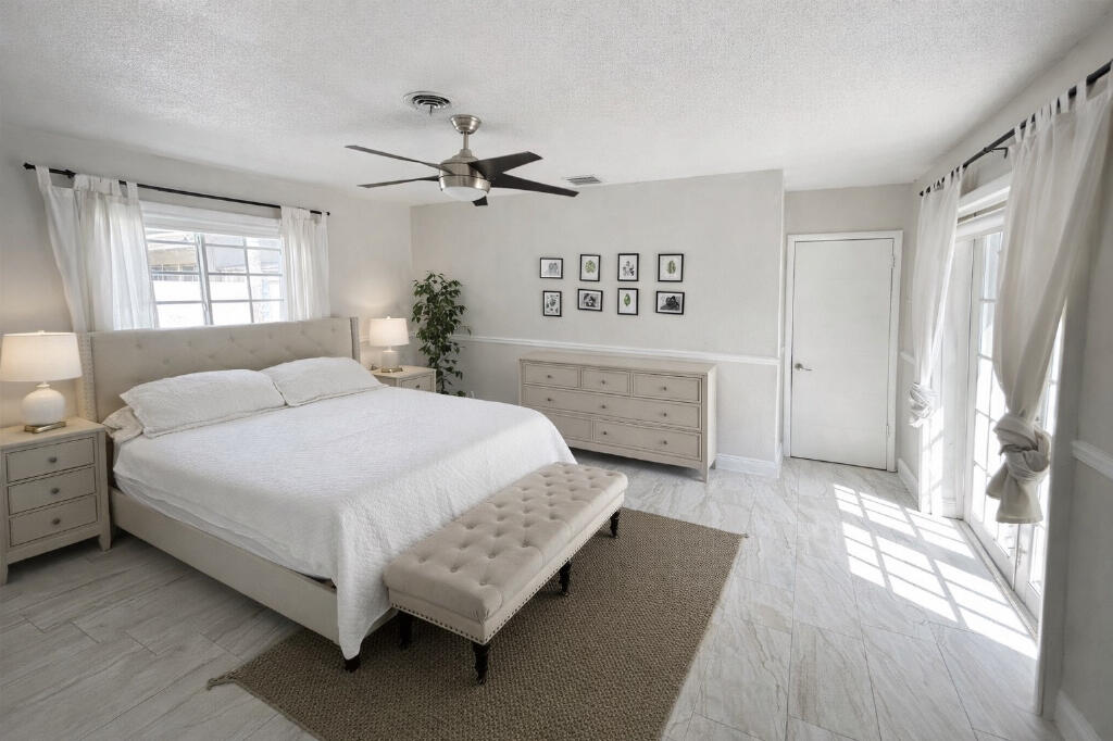 5408 Jackson Street Hollywood, FL 33021 - Photo 27 of 42 a spacious bedroom with a bed and a window