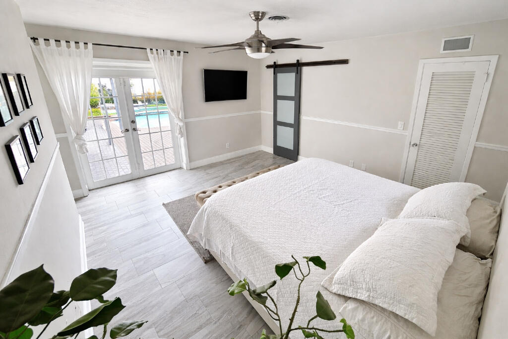 5408 Jackson Street Hollywood, FL 33021 - Photo 28 of 42 a bedroom with a bed and a television