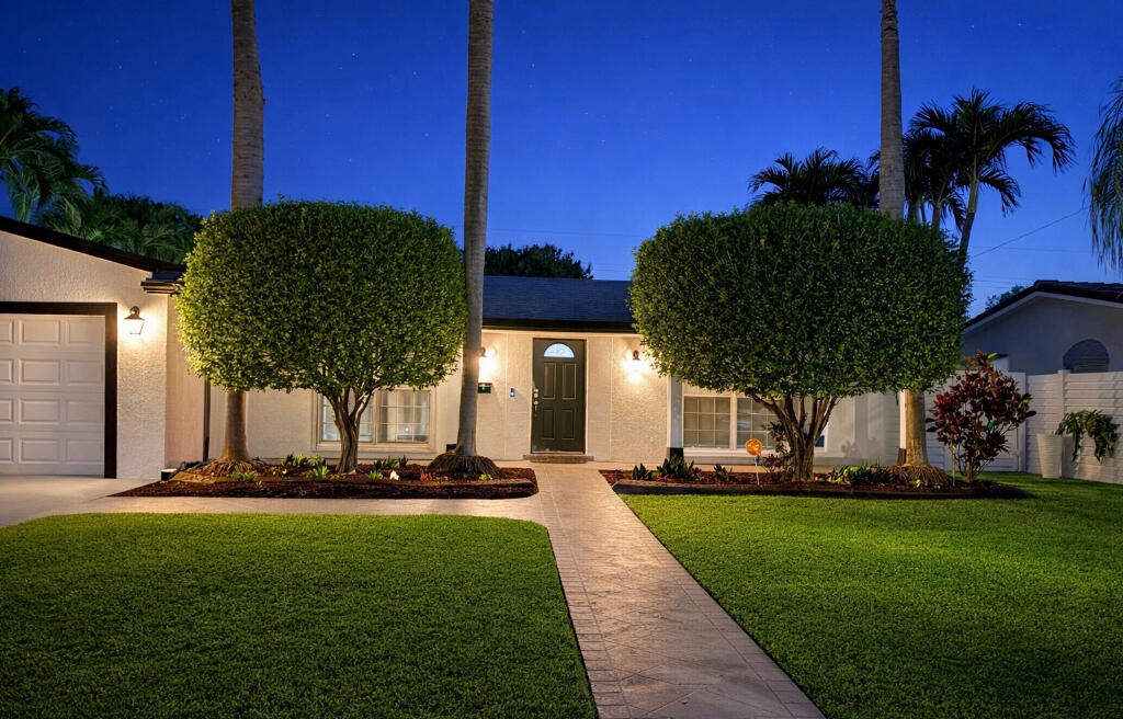 5408 Jackson Street Hollywood, FL 33021 - Photo 7 of 42 a front view of a house with a yard