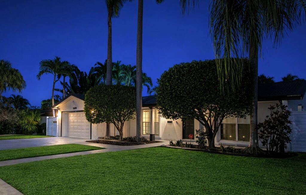 5408 Jackson Street Hollywood, FL 33021 - Photo 8 of 42 a front view of a house with a garden