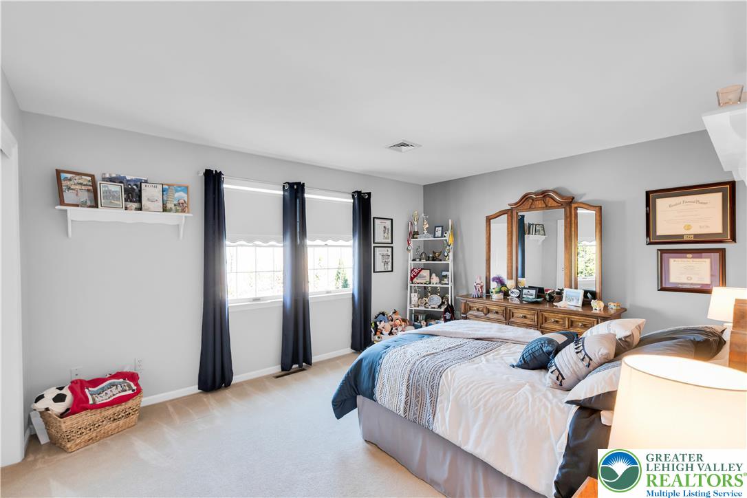 4059 Old Sentry Road Allentown, PA 18104 - Photo 24 of 39 The carpeted bedroom offers a comfortable atmosphere with ample natural illumination from the windows.