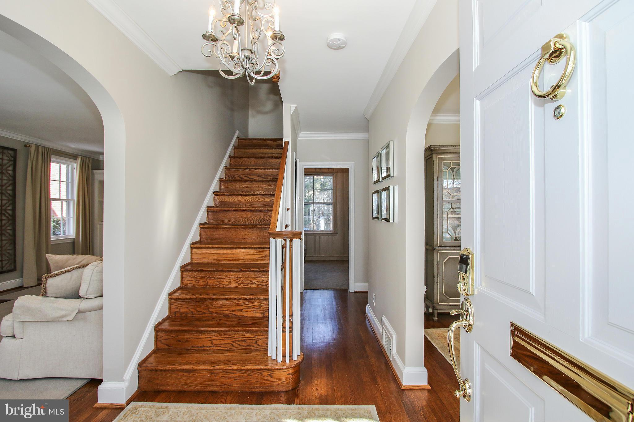 3231 Rittenhouse Street Northwest Washington, DC 20015 - Photo 2 of 27 a view of a hallway with wooden floor and staircase