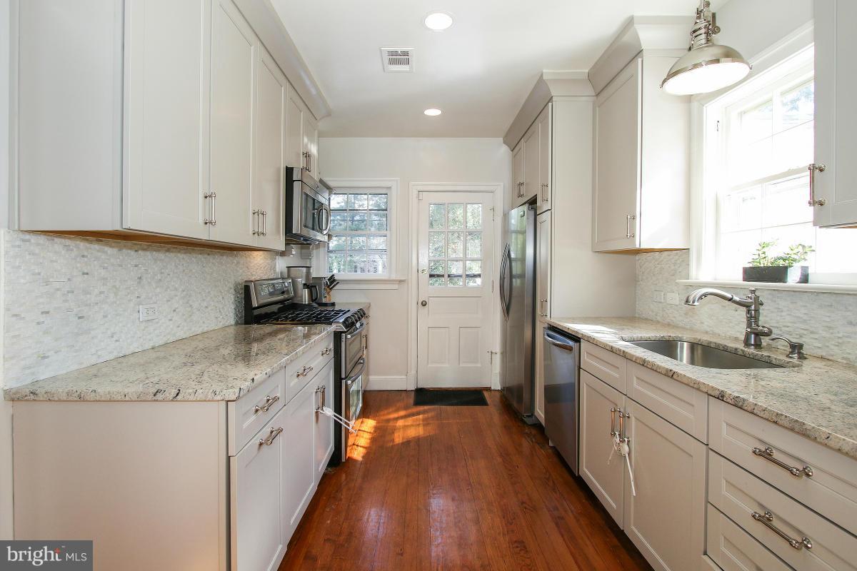 3231 Rittenhouse Street Northwest Washington, DC 20015 - Photo 11 of 27 a kitchen with a sink stove and refrigerator