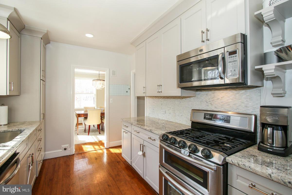 3231 Rittenhouse Street Northwest Washington, DC 20015 - Photo 13 of 27 a kitchen with stainless steel appliances granite countertop a stove and a microwave