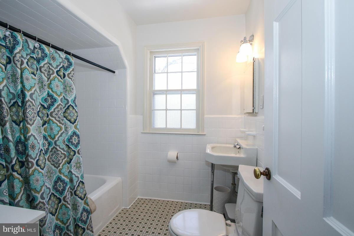 3231 Rittenhouse Street Northwest Washington, DC 20015 - Photo 15 of 27 a bathroom with a sink toilet and window