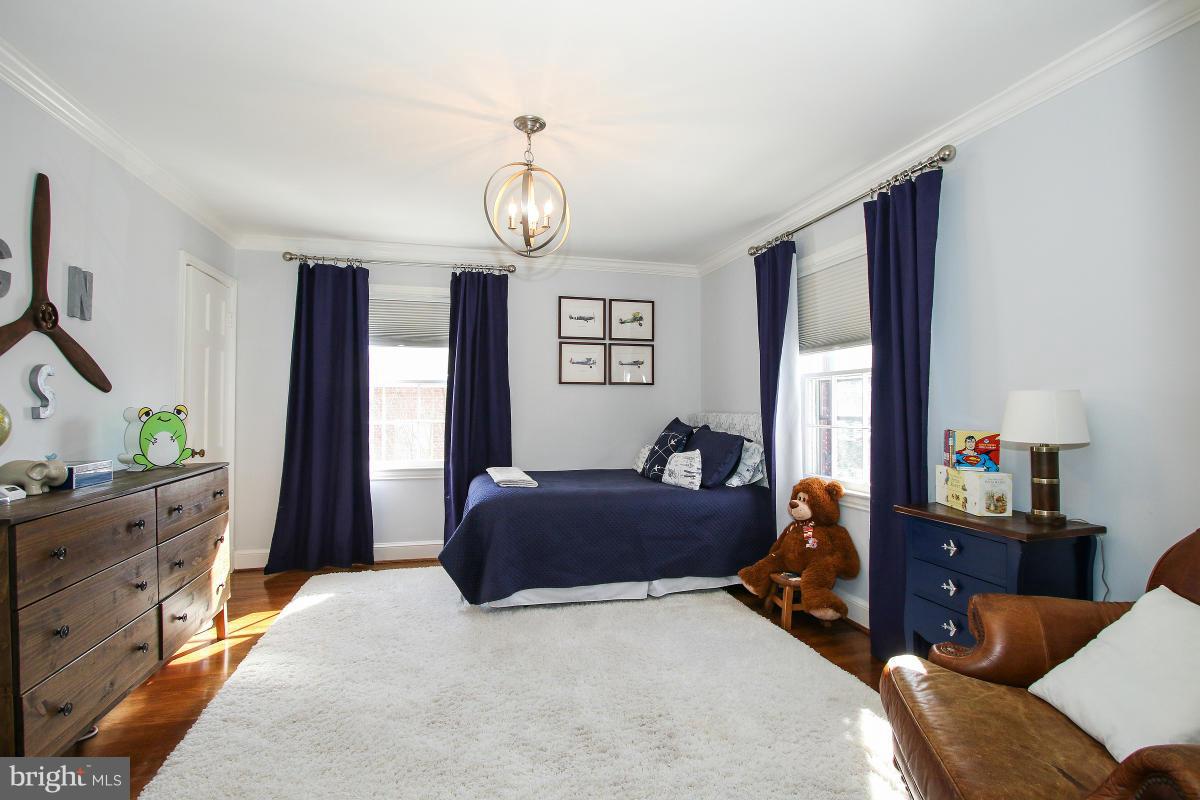 3231 Rittenhouse Street Northwest Washington, DC 20015 - Photo 16 of 27 a bedroom with a bed and wooden floor