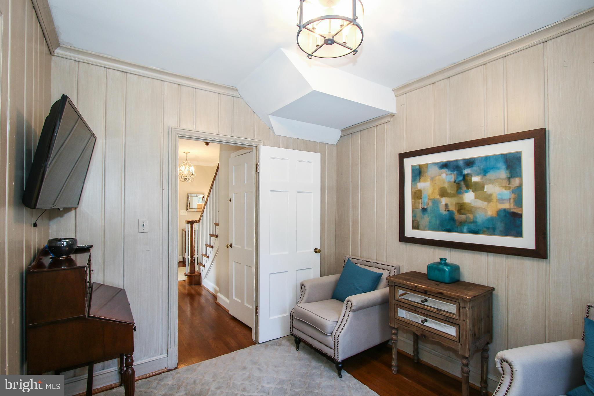 3231 Rittenhouse Street Northwest Washington, DC 20015 - Photo 7 of 27 a living room with furniture a flat screen tv and a wall painting