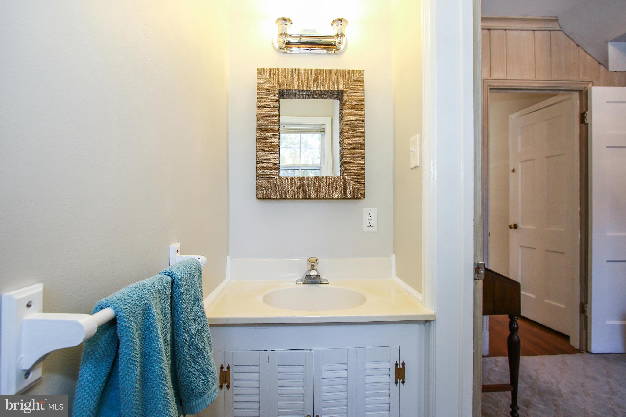 3231 Rittenhouse Street Northwest Washington, DC 20015 - Photo 8 of 27 a bathroom with a sink a mirror and a window
