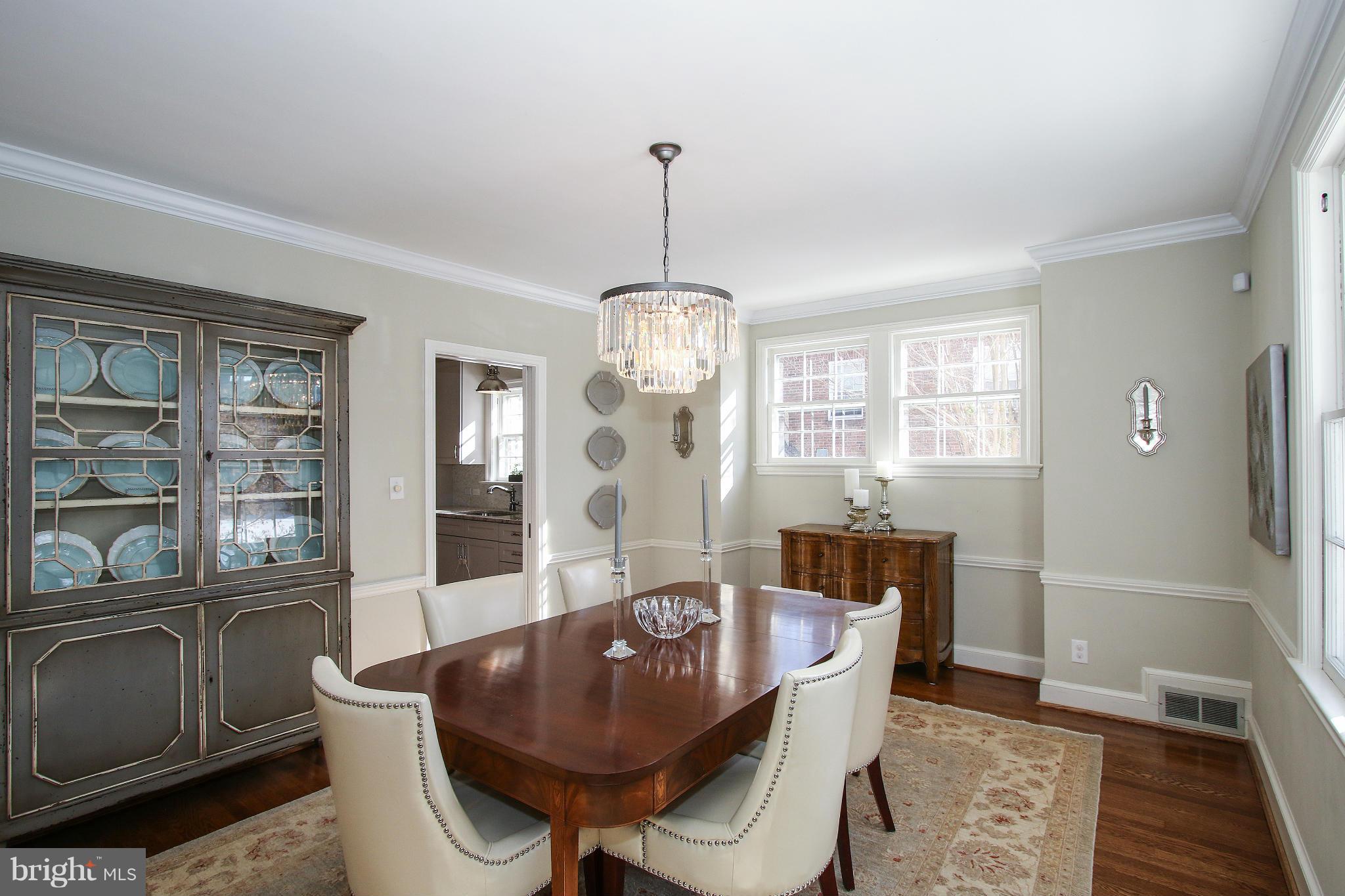 3231 Rittenhouse Street Northwest Washington, DC 20015 - Photo 9 of 27 a dining room with furniture a chandelier and wooden floor