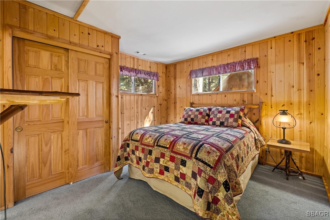 39585 Lakeview Pines Road Big Bear Lake, CA 92315 - Photo 20 of 49 a bedroom with a bed and wooden floor