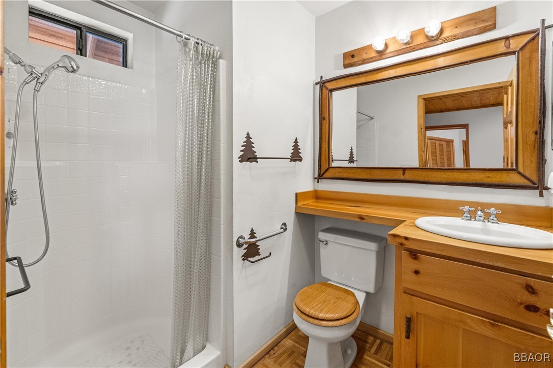 39585 Lakeview Pines Road Big Bear Lake, CA 92315 - Photo 26 of 49 a bathroom with a sink a toilet and a mirror