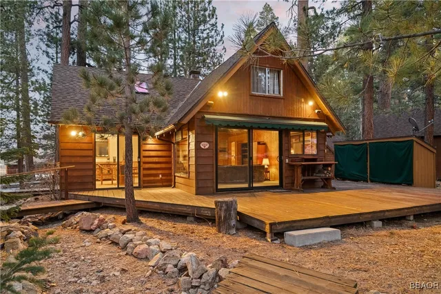 a backyard of a house with barbeque oven table and chairs