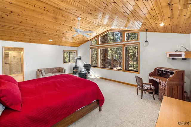 a spacious bedroom with a bed and a chandelier