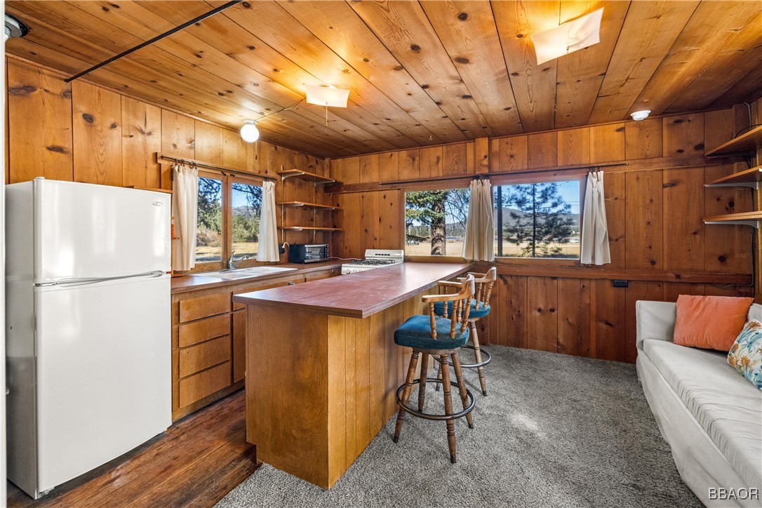 39585 Lakeview Pines Road Big Bear Lake, CA 92315 - Photo 41 of 49 a kitchen with stainless steel appliances a refrigerator a table and chairs