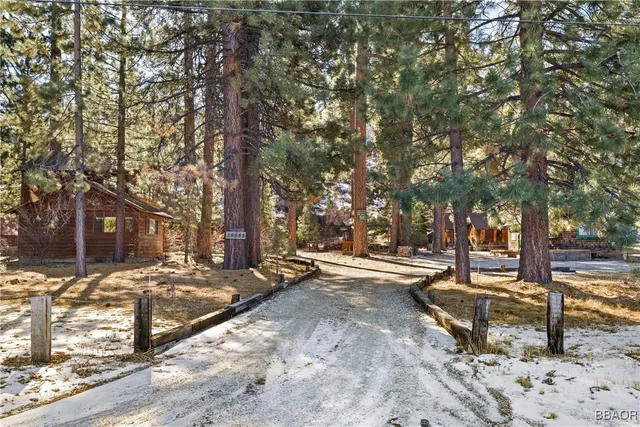 a view of a house with a yard covered in snow