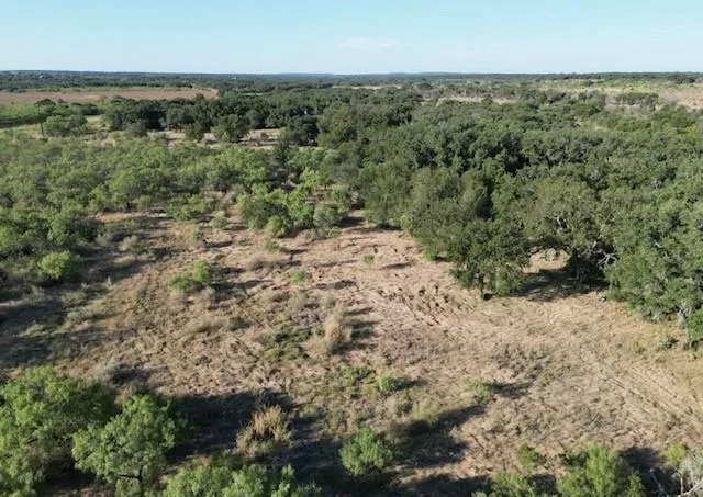 an aerial view of a houses with a yard