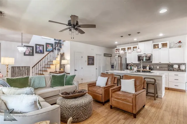 a living room with furniture and a view of kitchen