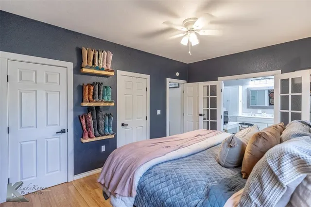a bedroom with a bed dresser and a book shelf