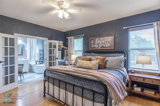 a bedroom with a large bed and a chandelier