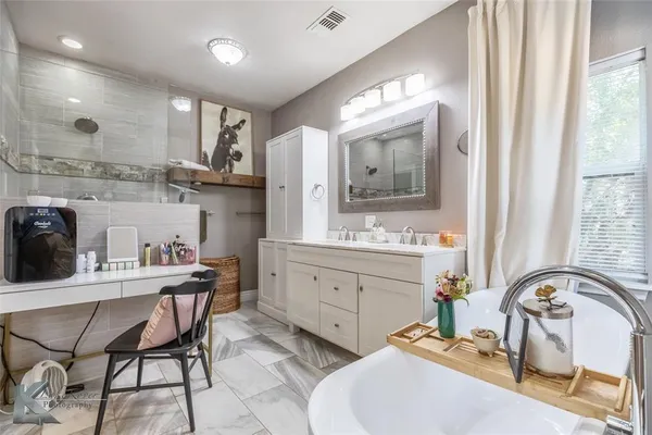 a bathroom with a sink double vanity and a mirror