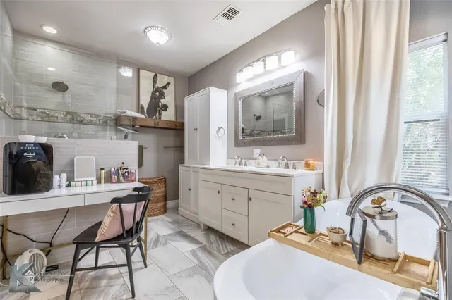 a bathroom with a sink double vanity and a mirror