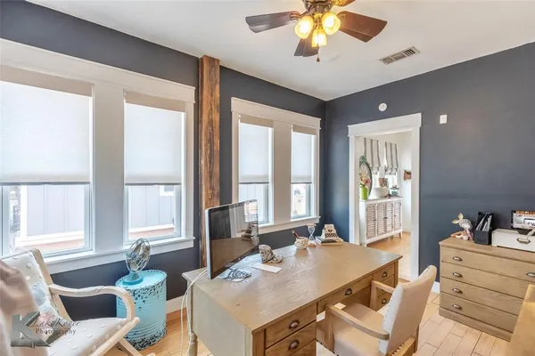 a view of a dining room with furniture a livingroom and chandelier