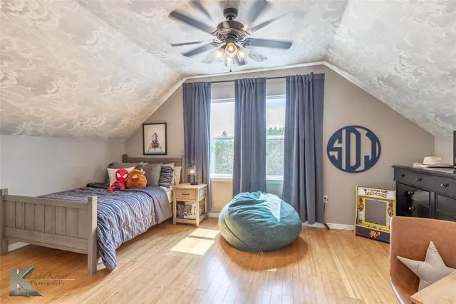 a bedroom with furniture and a large window