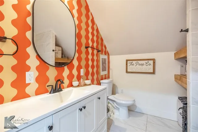 a bathroom with a toilet and a sink