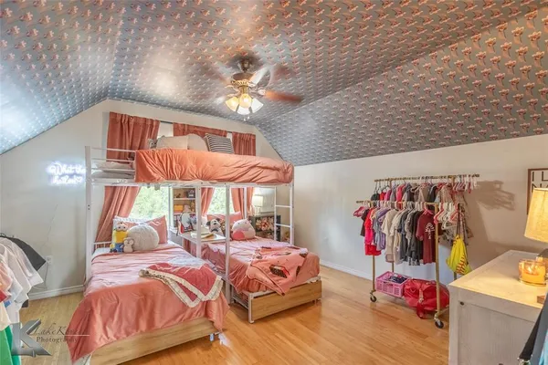 a bedroom with natural light and a bed