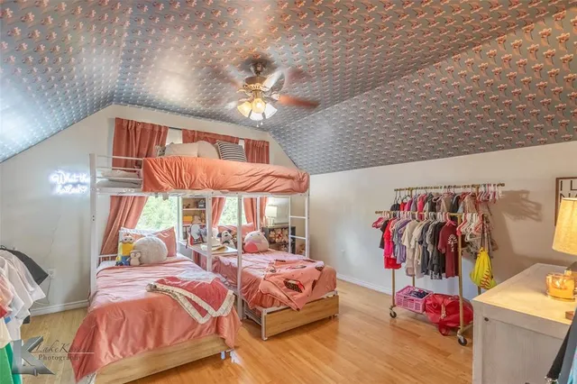 a bedroom with natural light and a bed