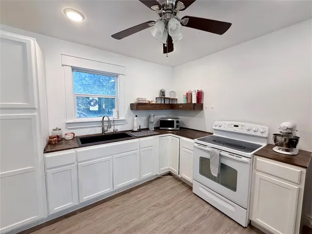 a kitchen with a stove and white cabinets